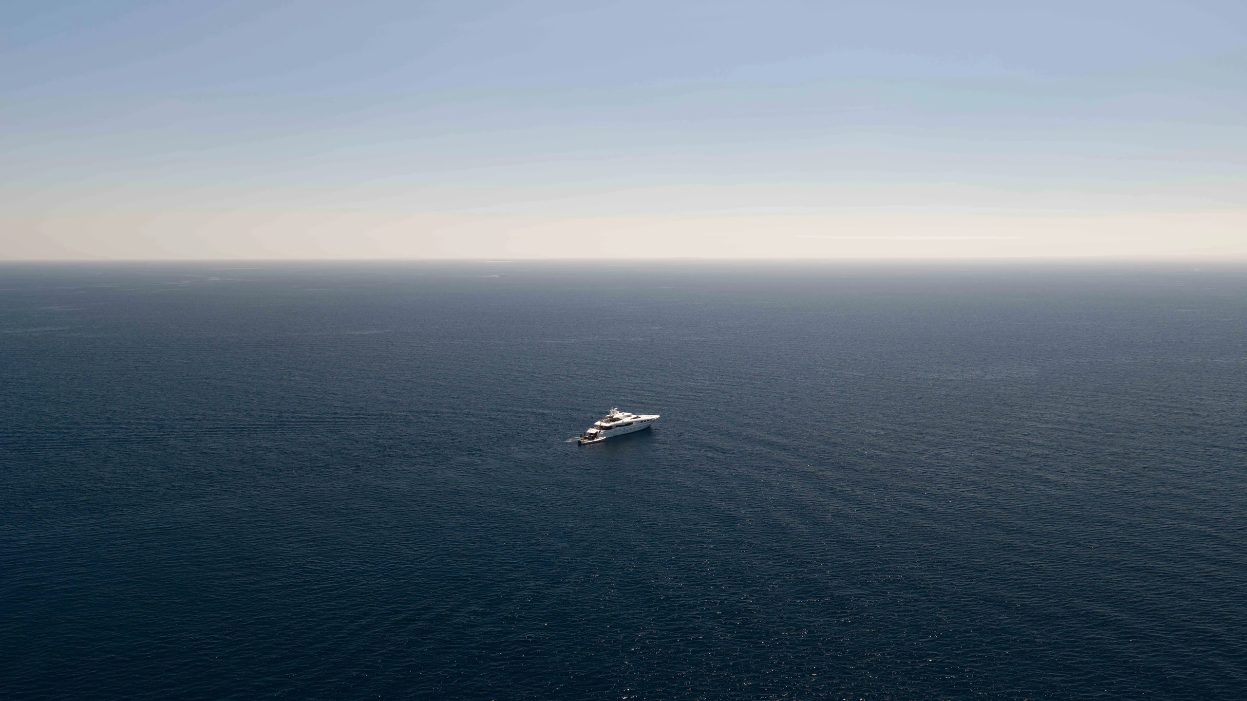 M/Y Impulsive alone on open blue water under a clear sky